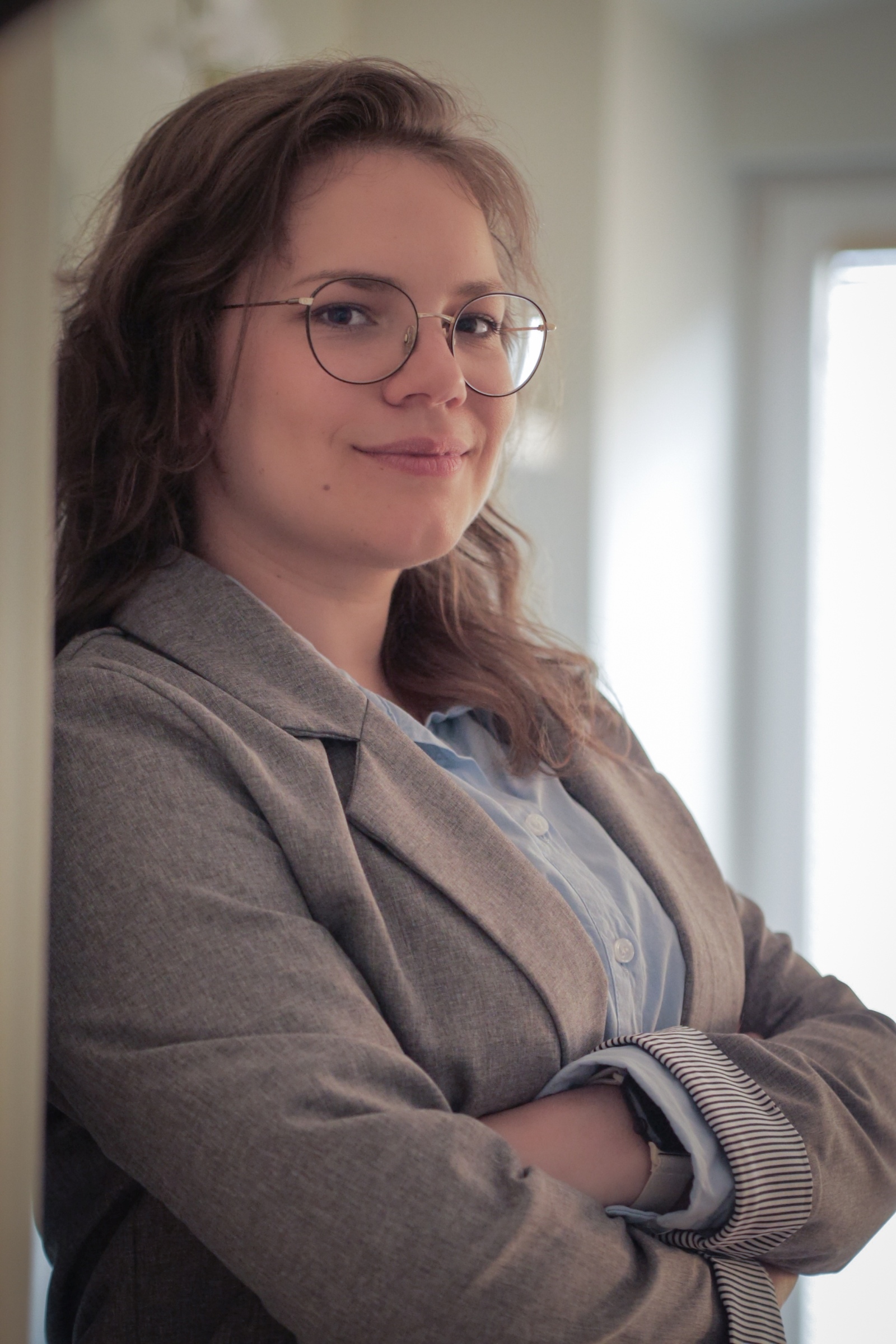 Therapist reflecting and writing notes in a quiet workspace